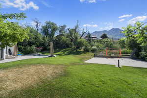 View of yard with a mountain view and a patio area