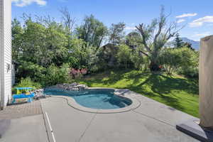 View of swimming pool with a mountain view, a yard, and a patio