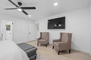 Bedroom with ceiling fan and light wood-type flooring