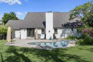 Rear view of property with a yard, french doors, and a patio