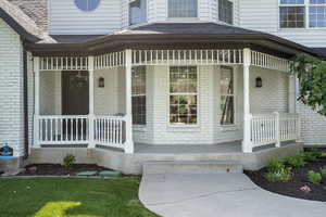 View of exterior entry with covered porch