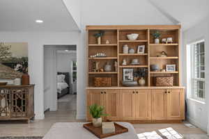 Living area with lofted ceiling and light wood-type flooring