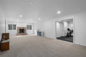 Carpeted living room with a fireplace