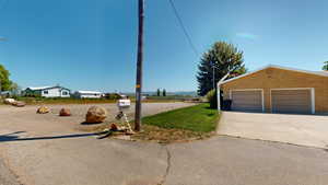 Exterior space featuring a garage and an outbuilding