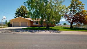 View of front of home featuring a garage and a front lawn