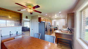 Dining space featuring light hardwood / wood-style floors and a textured ceiling