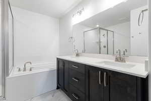 Bathroom with vanity and separate shower and tub