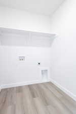 Laundry area featuring washer hookup, electric dryer hookup, and light hardwood / wood-style floors