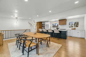 Dining room with light hardwood / wood-style floors and sink