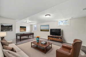 Carpeted living room featuring pool table