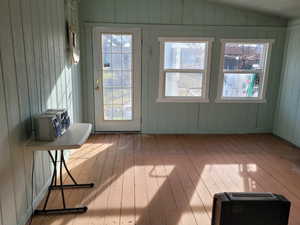 Enclosed porch area featuring lofted ceiling, and extra storage space