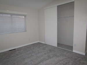 Bedroom #3 featuring new carpet and paint, and a closet