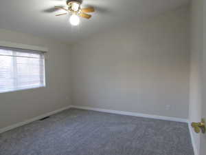 Bedroom #2 featuring ceiling fan and new carpet