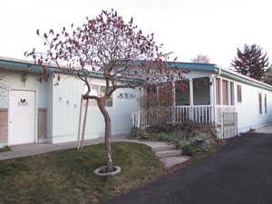 View of front facade featuring a porch and a front lawn