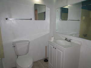 Apartment - Bathroom featuring tile patterned floors, vanity, and toilet