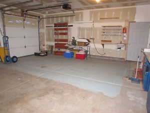 Garage with a garage door opener & extra storage