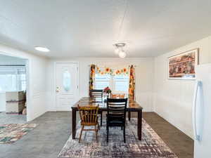 Dining room featuring plenty of natural light and dark wood-type flooring