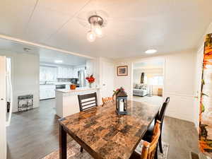 Dining room with sink and wood-type flooring