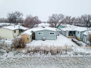 View of snow covered back of property