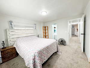 Bedroom featuring carpet and stainless steel fridge