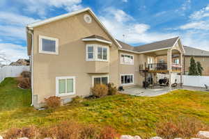 Back of property featuring a yard and a patio