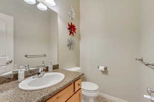 Bathroom featuring tile patterned floors, vanity, and toilet