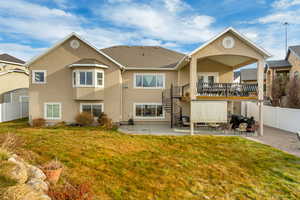 Back of house featuring a yard and 2 covered patios