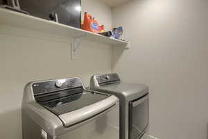 Laundry room featuring washer and clothes dryer