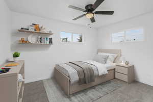 Bedroom #2 with light colored carpet and ceiling fan, virtual Staged