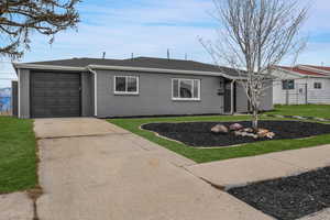Ranch-style house with a front lawn and a garage
