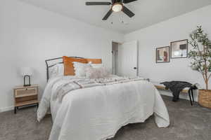 Main Bedroom with dark colored carpet and ceiling fan