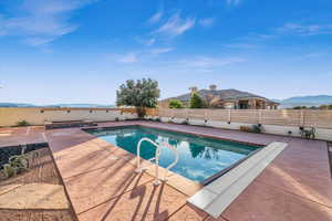 View of swimming pool with a mountain view and a patio area