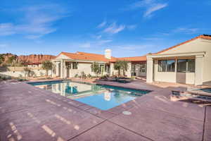 View of swimming pool featuring a jacuzzi and a patio