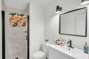 Bathroom with walk in shower, vanity, and toilet