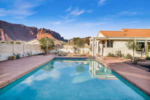 View of pool with a mountain view and a patio