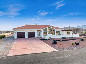 View of front of home featuring a mountain view and a garage