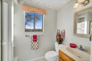 Bathroom featuring toilet, vanity, and tile patterned floors