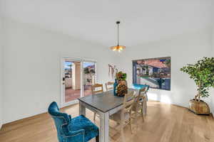 Dining room featuring an inviting chandelier and light wood-type flooring