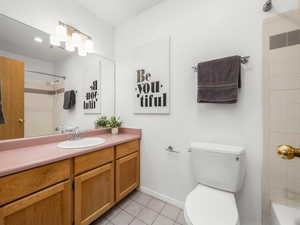 Bathroom with tile patterned flooring, vanity, and toilet