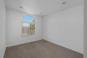 Empty room with light colored carpet