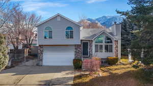 Split level home featuring a mountain view and a garage