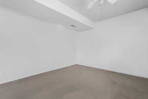 Unfurnished room featuring ceiling fan and carpet floors