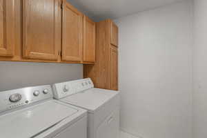 Laundry area with cabinets and washing machine and dryer