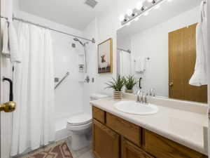 Bathroom with tile patterned flooring, vanity, toilet, and a shower with shower curtain