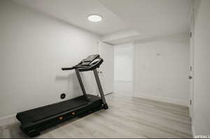 Workout room with light wood-type flooring