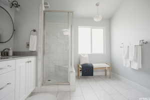 Bathroom with vanity and a shower with door