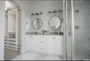 Bathroom featuring vanity and an enclosed shower