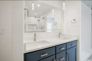 Bathroom featuring vanity and a shower with door