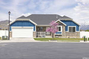 Craftsman inspired home featuring a mountain view, a porch, and a garage