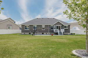 Back of property with a lawn and a pergola